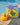 Children's bath book by W.E.Kiwi and a rubber kiwi bath toy on a stone surface near a pool.